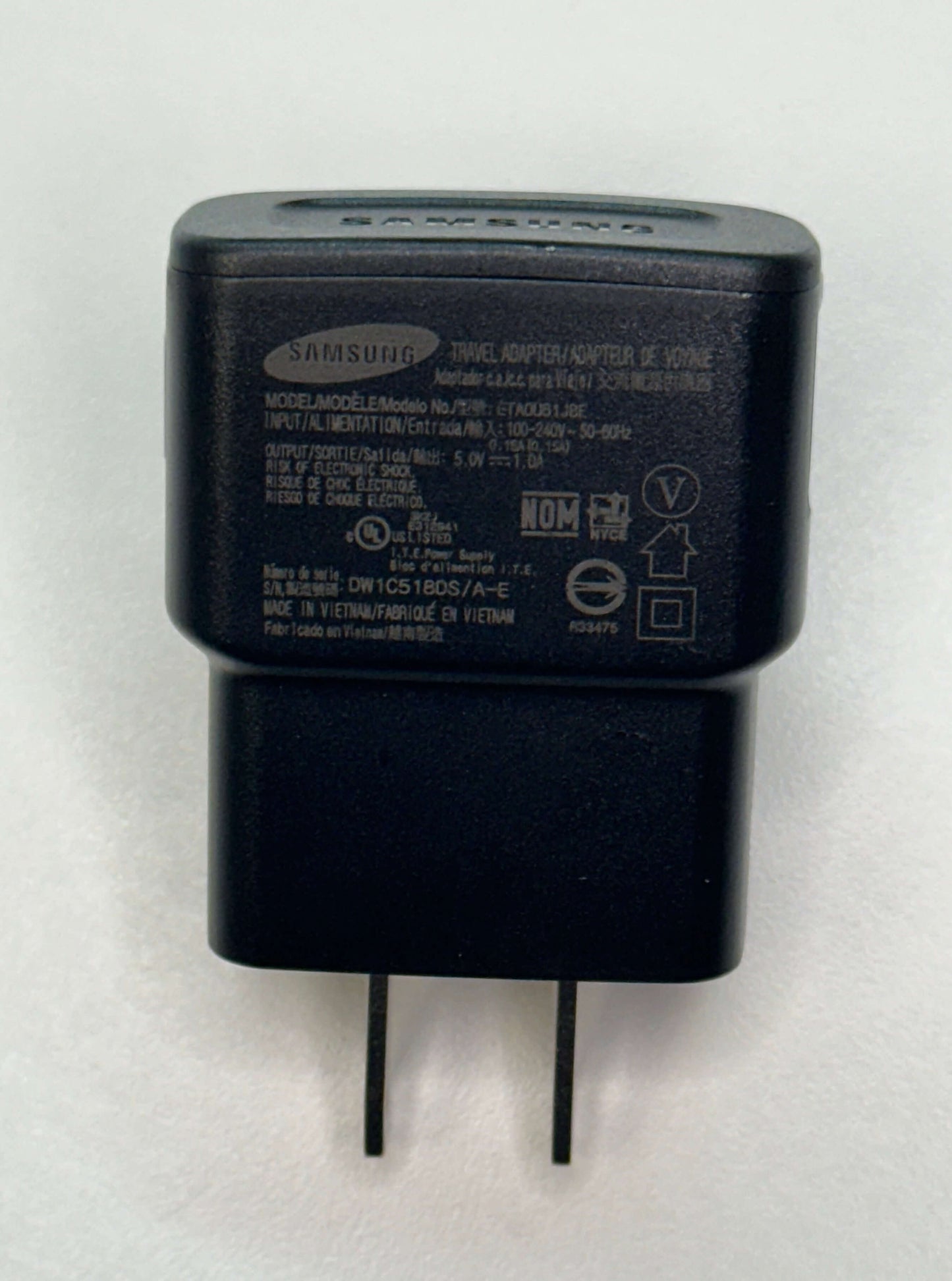 Samsung USB wall plug charger with 1AMP output, compact design, suitable for USB-A devices, black color.